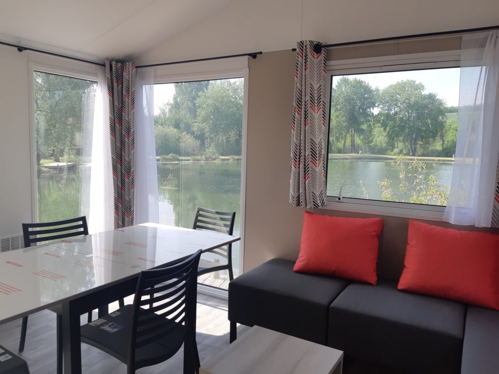 Séjour panoramique du mobil-home Le Gardon avec vue sur l'étang